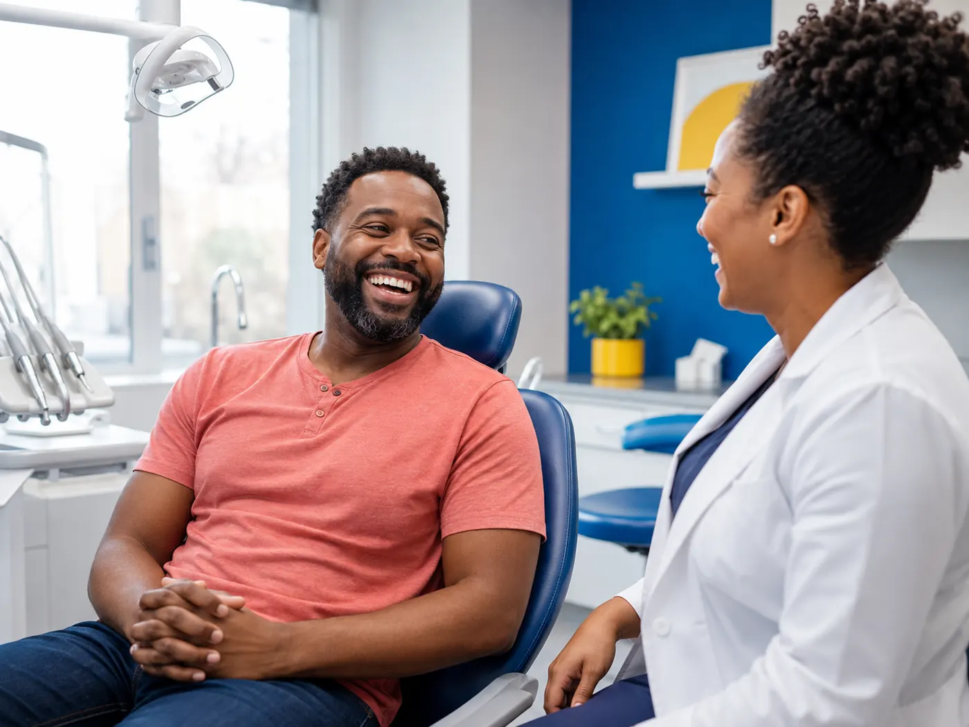 A patient laughing during a relaxed conversation with a dental professional
