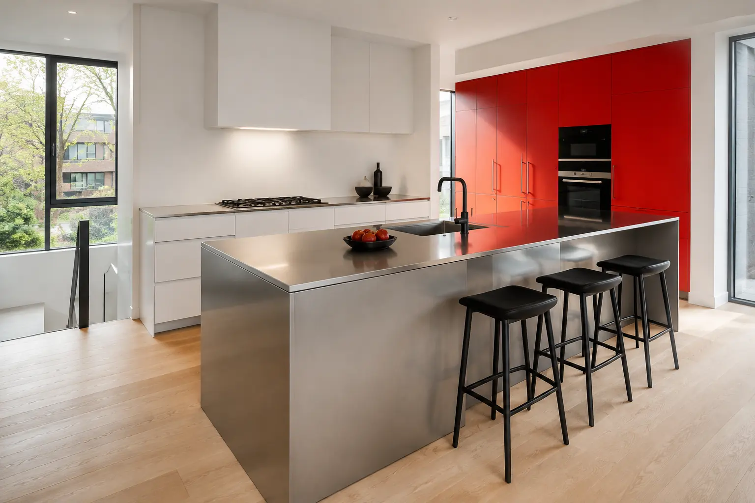 Warm white GRIDFORM concept kitchen with a brushed metal island and signal-red cabinet wall
